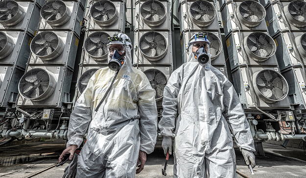 Two people in hazmat suits