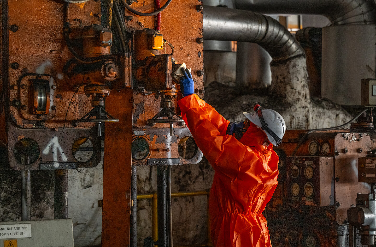 A waste worker in protective outfit
