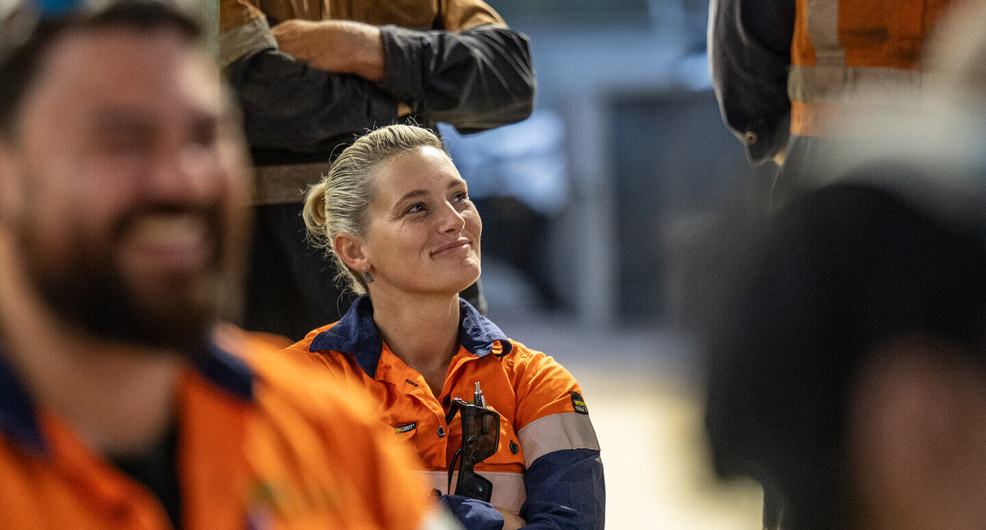 A woman smiling away from camera